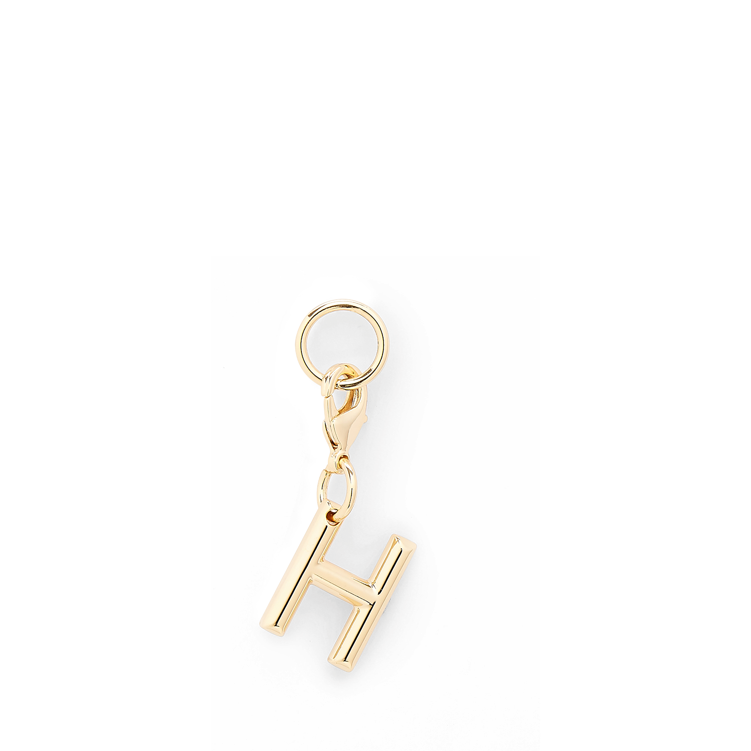 Gouden metalen Lancel-bedel in de vorm van de letter H, met een gepolijste afwerking. LANCEL Goud