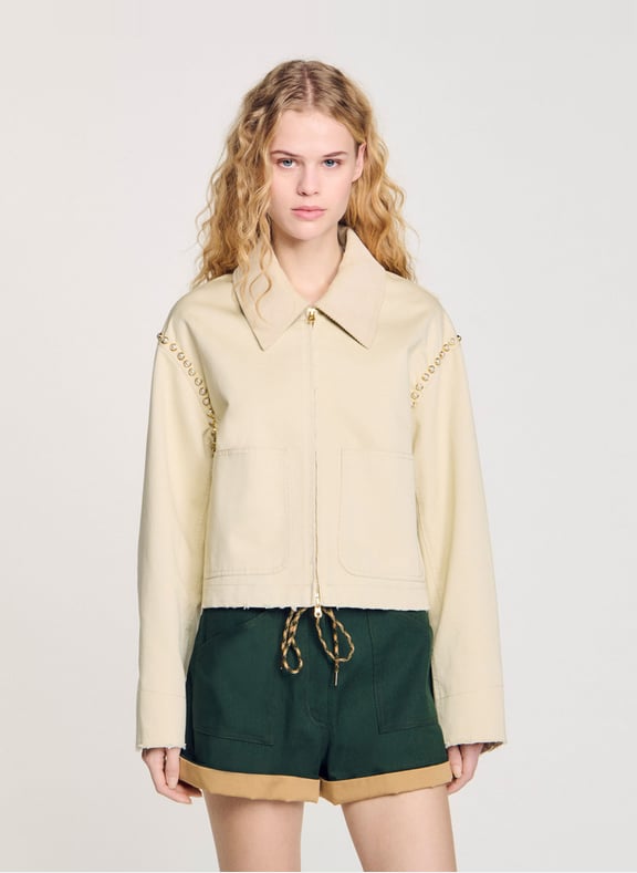 Veste courte droite avec détail clouté Beige by SANDRO SANDRO Veste courte droite avec détail clouté Beige