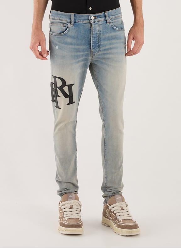 Jean slim délavé à logos Bleu by AMIRI AMIRI Jean slim délavé à logos Bleu